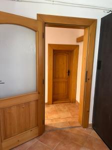 an empty room with two doors and a tiled floor at Jastrabie House in Trenčianske Jastrabie