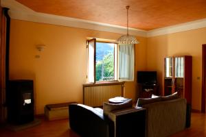 a living room with two couches and a window at Casa di Cristian in Pian di Mulino