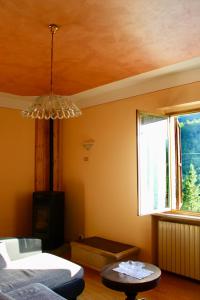 a living room with a couch and a window at Casa di Cristian in Pian di Mulino +17 photos