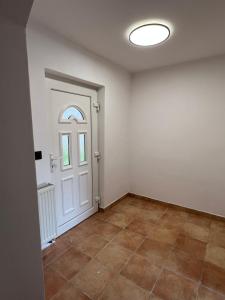 an empty room with a door and a tile floor at Jastrabie House in Trenčianske Jastrabie