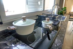 a bathroom with a sink and a toilet on a counter at Departamento de Lujo a 8 min del centro in San Nicolás de los Arroyos
