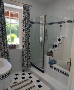 a bathroom with a shower and a tub and a sink at Privatzimmer in Steinfeld