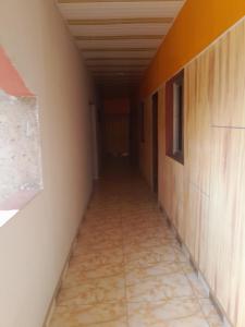 an empty corridor of a room with a corridorngthngthngthngthngthngthngth at Residence Hotel Kolia in Yamoussoukro