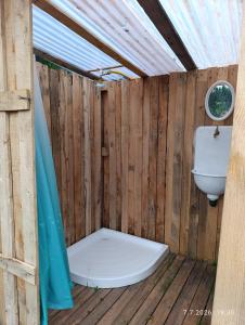 a wooden bathroom with a toilet and a sink at Útulná Maringotka in Dolní Město +19 photos