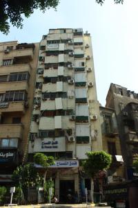 a tall building with balconies on the side of it at El Temsah Hotel in Cairo