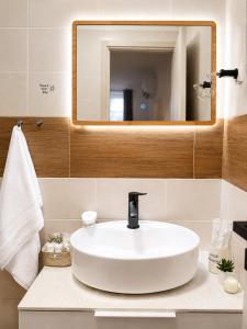 a bathroom with a white sink and a mirror at Room Jakov in Šibenik
