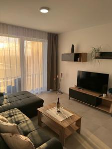 a living room with a couch and a coffee table at Panoráma apartman in Dolný Čepen
