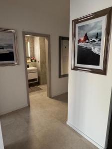 a hallway with two pictures on the wall of a room at Panoráma apartman in Dolný Čepen