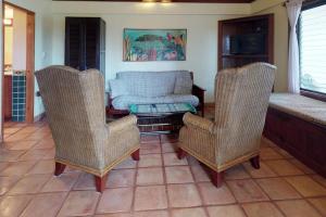 a living room with two chairs and a couch at Condo #31 @ Beachside Villas in Placencia