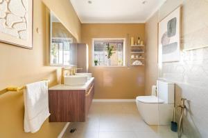 a bathroom with a sink and a toilet at The Quinta & Studios in Quinta do Conde