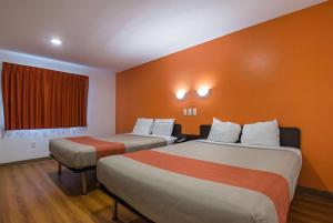 a hotel room with two beds and a window at Atlantic Inn Marshalltown, Iowa in Marshalltown