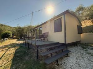 a tiny house with stairs leading up to it at Amici del Colle - Olive Tiny Houses in Borgo a Buggiano