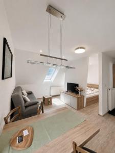 a living room with a couch and a tv at Apartmaji Kramar Rateče in Kranjska Gora
