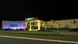 a hotel with purple lights in front of a building at Leblon Motel in Barretos