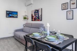 a living room with a table and a couch at Enjoy and Fly, NEAR THE AIRPORT AND THE SEA in Fiumicino