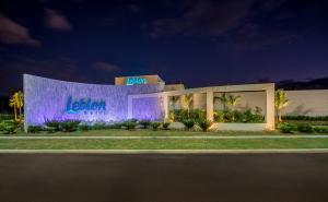 a building with a lit up facade at night at Leblon Motel in Barretos
