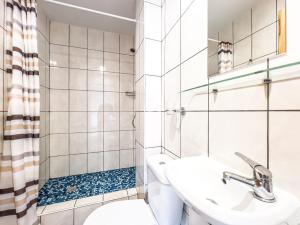 a bathroom with a sink and a toilet and a shower at Pensjonat Viki in Sarbinowo +52 photos
