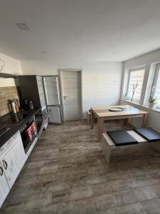 a kitchen with a table in the middle of a room at Dorfquartier am Gut in Remstädt +1 photo