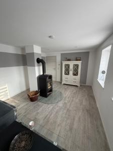 a living room with a wood burning stove in it at Dorfquartier am Gut in Remstädt