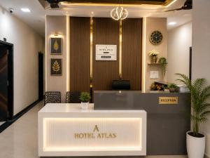 a hotel atlas reception desk in a lobby at Hotel Atlas in Raigarh