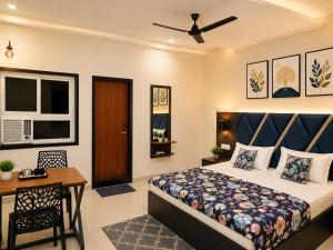 a bedroom with a bed and a desk and a window at Hotel Atlas in Raigarh +5 photos
