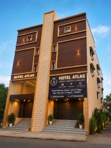 a hotel with a sign on the front of it at Hotel Atlas in Raigarh