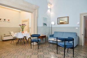 a living room with blue chairs and a table at Dimora San Vito in Lequile