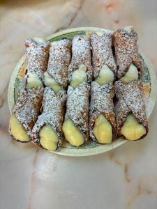a plate of cookies covered in powdered sugar at Casa Cilone in Ragusa