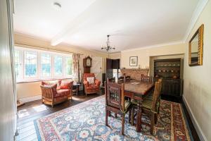 a dining room with a table and chairs and a living room at Primrose Spinney in Ringwood