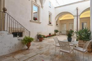 a patio with a table and chairs in a building at Dimora San Vito in Lequile