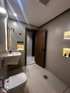 a bathroom with a toilet and a sink at Dara in Al Khobar