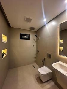 a bathroom with a toilet and a sink at Dara in Al Khobar