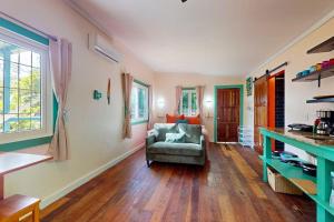 a living room with a couch and a chair at Casita in Placencia