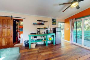 a kitchen with a blue table and a refrigerator at Casita in Placencia