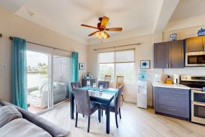 a kitchen and dining room with a table and a couch at Suite H103 @ Mara Laguna in San Pedro