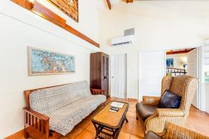a living room with a couch and two chairs at Condo #26 @ Beachside Villas in Placencia