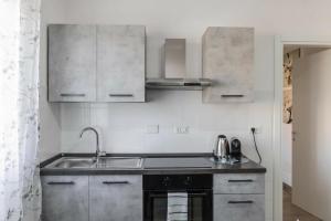 a kitchen with a sink and a stove at Enjoy and Fly, NEAR THE AIRPORT AND THE SEA in Fiumicino