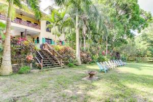 a group of chairs in the yard of a house at Crow's Nest Suite at Mahogany Hall -Gold Standard Certified in San Ignacio