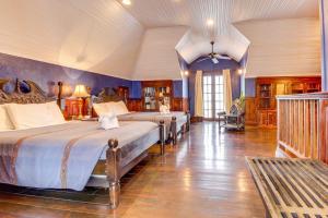 a bedroom with two beds in a room at Crow's Nest Suite at Mahogany Hall -Gold Standard Certified in San Ignacio +16 photos