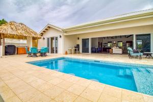 a swimming pool in a backyard with a house at Tres Palmas Beach House in Maya Beach