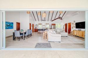 a living room with a couch and a table at Tres Palmas Beach House in Maya Beach