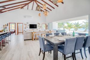 a dining room with a table and chairs at Tres Palmas Beach House in Maya Beach