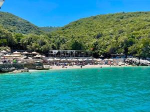 a beach with a group of people in the water at Villa Stefano Stepa in Tragjas