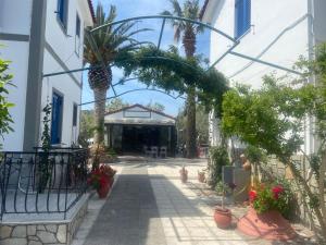 an archway with potted plants and a building at Anaxos Garden in Anaxos