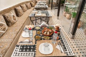 a table with plates of food on top of a table at Riad Al Fanouss in Fez