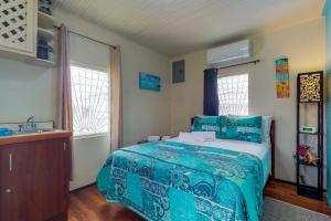 a bedroom with a bed and a sink at DV #1 at DV Cabanas - Gold Standard Certified in Caye Caulker +15 photos