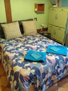 a bedroom with a bed with blue towels on it at MAISON PRATS in Audon