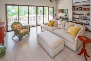 a living room with a couch and a chair at The Reserve in Dangriga