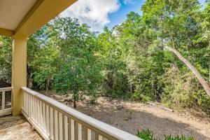 a porch with a view of the woods at The Reserve in Dangriga