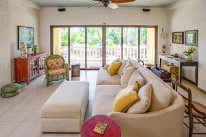 a large living room with a large couch at The Reserve in Dangriga +41 photos